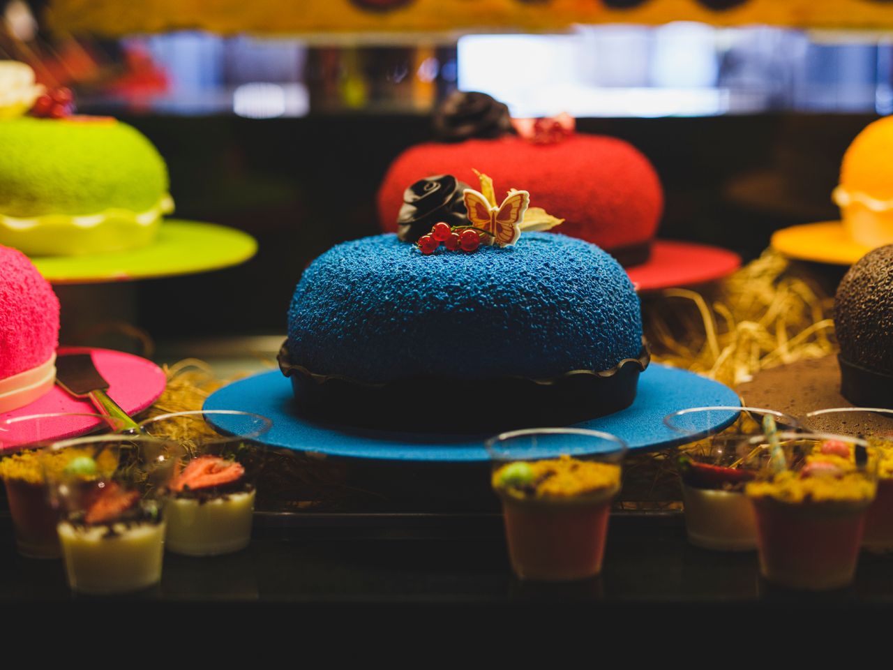 Vibrant display of assorted colorful cakes and desserts, perfect for celebrations.